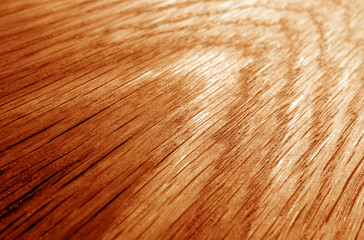 Naklejka premium Wooden board texture with blur effect in orange tone.