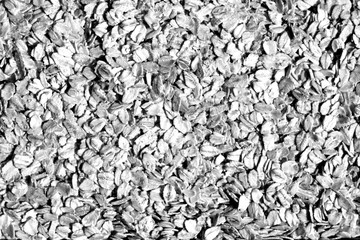 Pile of oatmeal close-up in black and white.