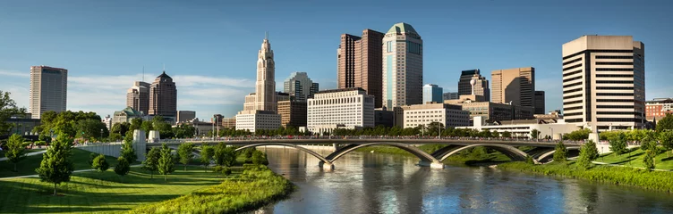 Fotobehang Downtown cityscape panoramic looking over the Scioto River and the Discovery Bridge along the Riverfront Park in the city of Columbus Ohio USA © Aevan