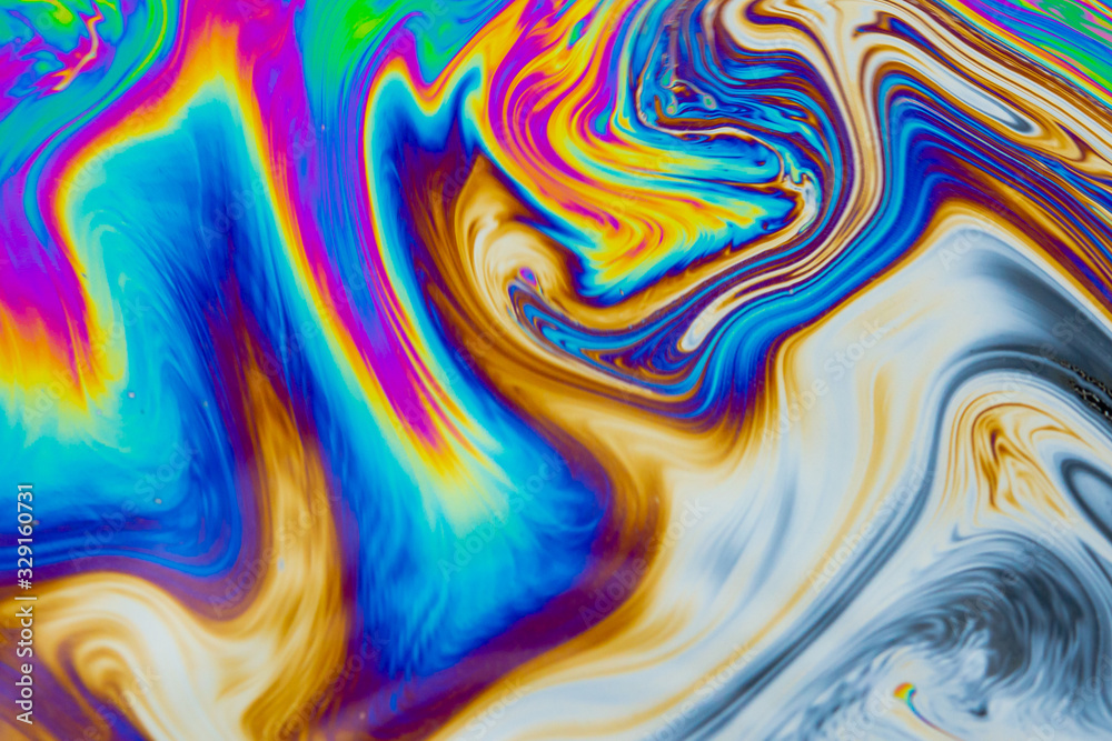 Wall mural psychedelic abstract background. photo macro shot with light interference on the surface of a soap b