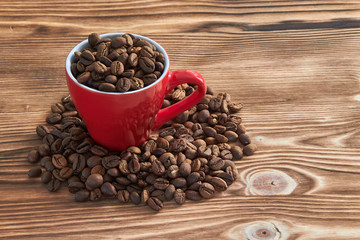 cup with coffee beans on wooden table