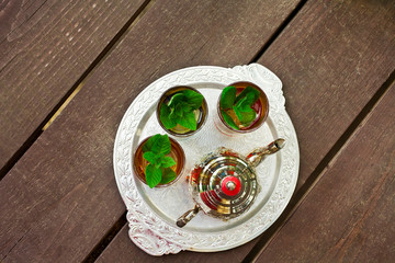Moroccan mint tea on a wooden table. Top view.