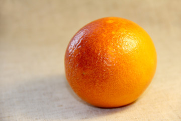 Sicilian Mandarin on a beige linen background. Red citrus fruit.