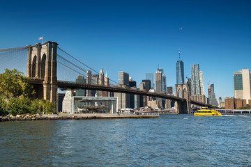 East River shoreline boardwalk under the Brooklyn Bridge as seen from the DUMBO area in New York USA