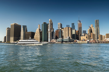Fototapeta na wymiar Lower Manhattan downtown urban cityscape over the East River from Brooklyn New York USA