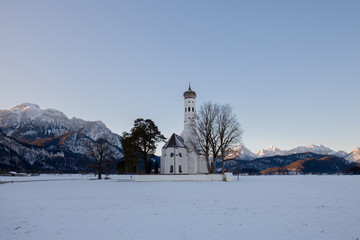 St. Coloman church at sunrise in winter. Allgäu, Germany