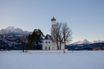 St. Coloman church at sunrise in winter. Allgäu, Germany