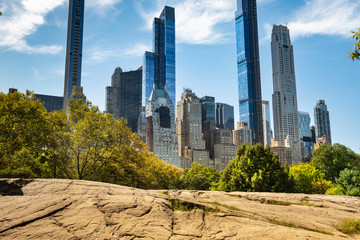 Apartment and condominium skyscraper residences rise up over the Manhattan skyline in Central Park in New York City USA