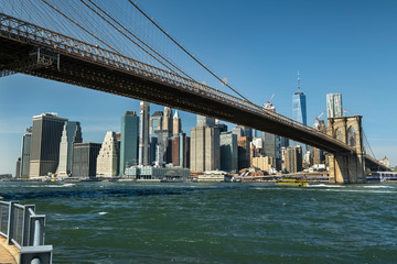 East River shoreline under the Brooklyn Bridge as seen from the DUMBO area in New York USA