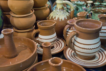 Pottery jugs at the fair. Handicrafts of folk potters.