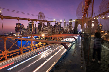 Traffic moves across the Brooklyn Bridge connecting Manhattan New York City over the East River