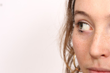 Fototapeta premium Sweet looking pretty young girl with freckled skin and green eyes