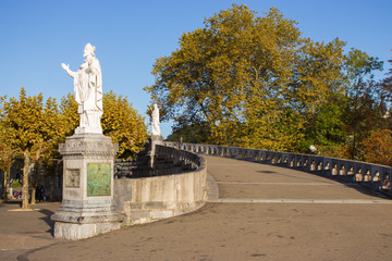 Obraz premium Lourdes, France - 09/29/2019: Statues of saints in park near Sanctuary of Our Lady in Lourdes, France. Famous religious centre of pilgrims. Spiritual travel. Faith and miracle concept.