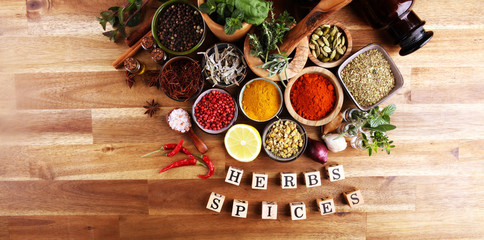 Spices and herbs on table. Food and cuisine ingredients with pepper and spices herbs sign with wooden cubes