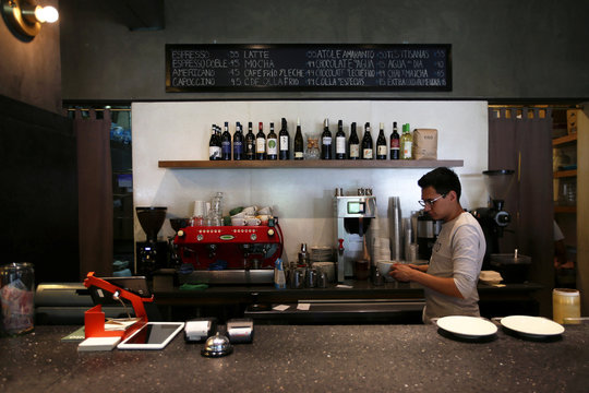 A male employee makes coffee in a cafeteria after his female colleagues stayed away from work during the "A Day Without Women" protest, as part of the escalation of historic protests against gender violence, in Mexico City