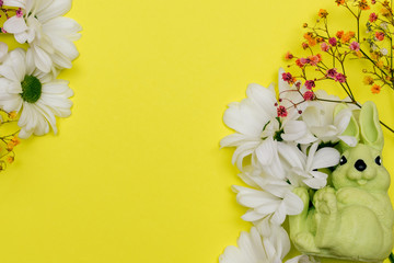 Happy Easter concept flat lay. Sprigs of соlorful gypsophila (baby's breath flowers) with white...
