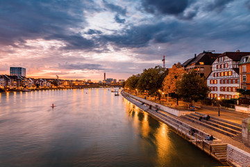 Obraz premium Basel, Switzerland. View over Rhine river at Basel city during amazing sunset. Amazing seasonal autumnal scenery.