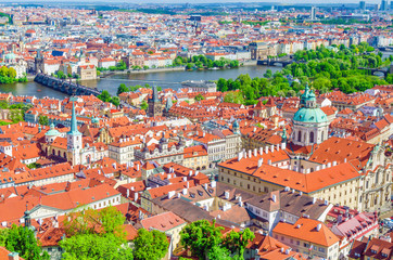 Top aerial view of Prague historical city centre with red tiled roof buildings in Mala Strana...