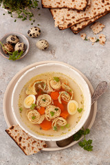 Soup on chicken broth with egg pancakes and matzo bread. Pesah celebration concept (jewish Passover holiday