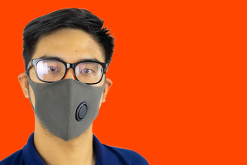 Asian man headshot portrait. In concepts of Coronavirus or COVID-19 and PM2.5 pollutions. Epidemic virus symptoms around the world in early 2020.