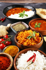 Chicken tikka masala spicy curry meat food in pot with rice and naan bread. indian food on table