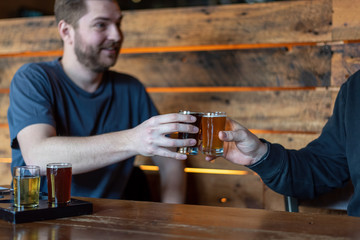 Two guys hanging out talking and having a beer