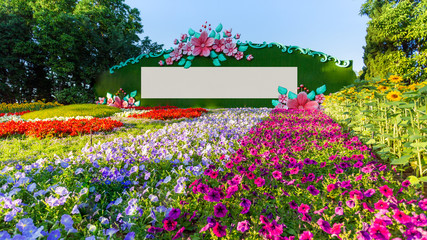 Beautiful flowers garden and a blank billboard