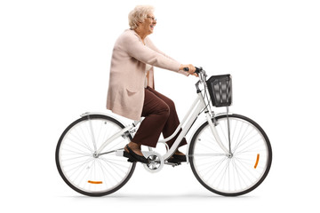 Senior woman riding a bicycle and smiling