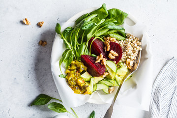 Healthy green salad with beetroot and sprouted green buckwheat, top view. Healthy vegan food concept.