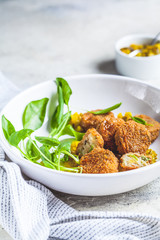 Vegan vegetable meatballs with spinach and green dressing.
