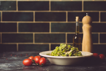 Italian pasta food background. Vegan italian pasta with spinach (Spinach Fettuccine Alfredo Pasta) on a white plate. Old kitchen background. Copy space