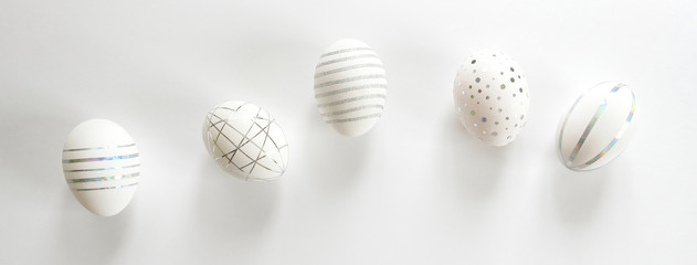 White easter eggs with silver pattern on white