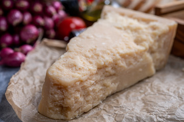 Obraz na płótnie Canvas One piece of authentic Parmigiano-Reggiano or Parmesan Italian hard, granular cheese