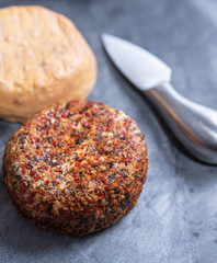 Different french soft goat cheeses made with spices and herbs