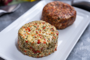 Different french soft goat cheeses made with spices and herbs