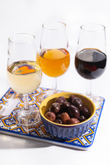 Fortified wine from Andalusia, Spain, different types of sherry in glasses and olives on white background