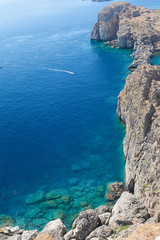 top view of the sea surface. The edge of a rocky cliff.  Vertical orientation. Greece, Rhodes