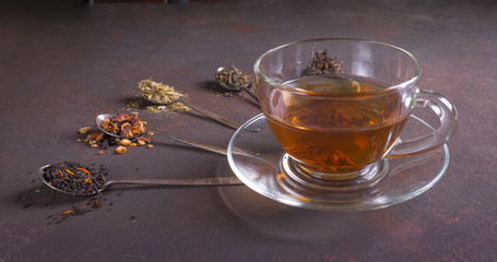 Different black and green dry tea. Top view. Space for text. Cup of tea.
