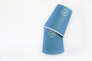 ppaper cups recyclable in blue with text " 100% compostable" on a white background. ecological concept