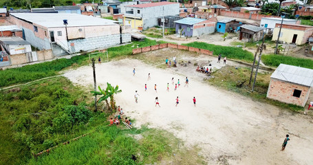 Manaus/Amazonas/Brazil - 10/10/2018 - poor children playing futebol in a sand field at slum.