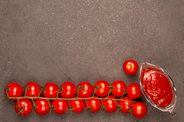 Ripe cherry tomatoes on a black background, top view with copy space