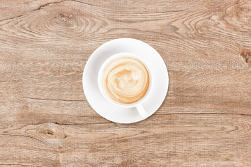 Phone and coffee on a vintage wooden background. Technology concept background. White screen phone copy space. Concept photos of desks / commercial backgrounds.
