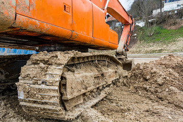 Tracks of a excavator machine on a construction site.