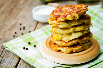 zucchini corn fritters on a wood background