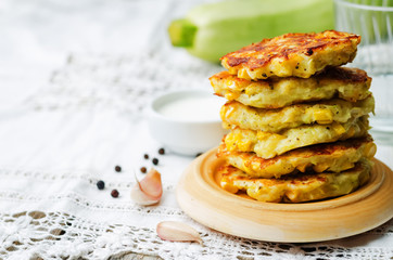 zucchini corn fritters on a wood background