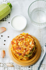 zucchini corn fritters on a wood background