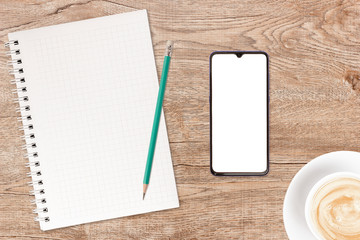 Phone and coffee on a vintage wooden background. Technology concept background. White screen phone copy space. Concept photos of desks / commercial backgrounds.