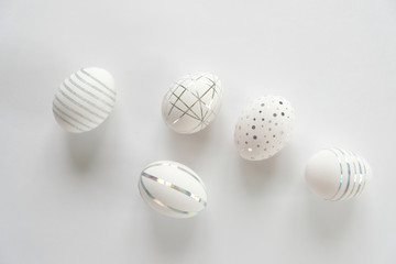 White easter eggs with silver pattern on white