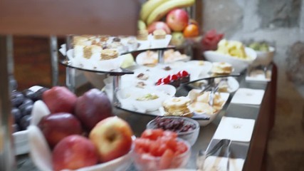 The camera flies over the buffet table