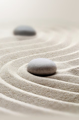 Fototapeta na wymiar zen garden meditation stone background with stones and lines in sand for relaxation.